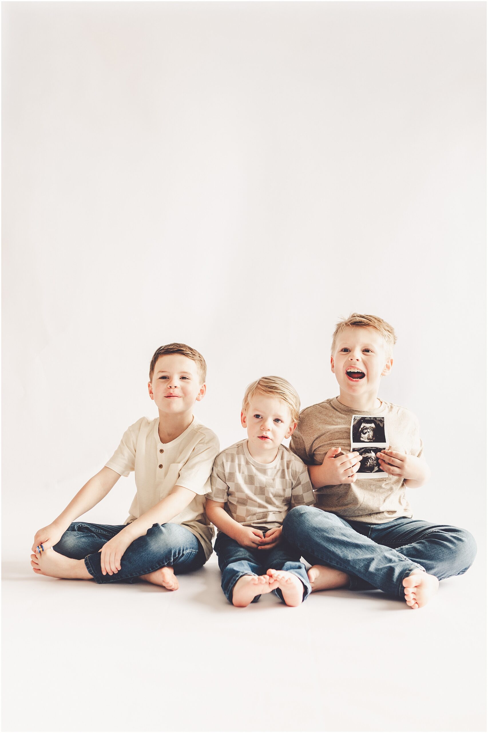 Studio pregnancy announcement family photo ideas with Kankakee family photographer Kara Evans Photographer.