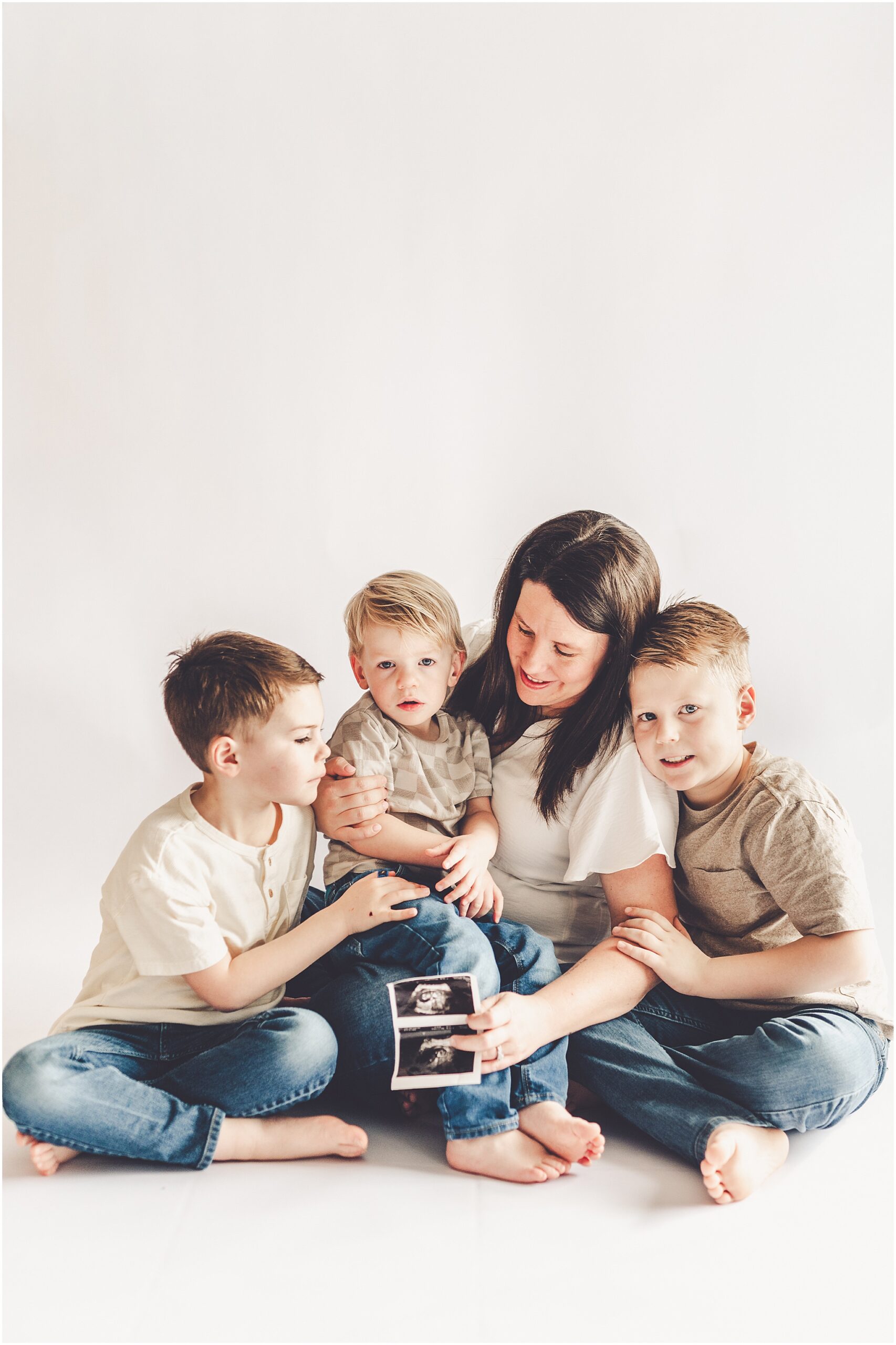 Studio pregnancy announcement family photo ideas with Kankakee family photographer Kara Evans Photographer.