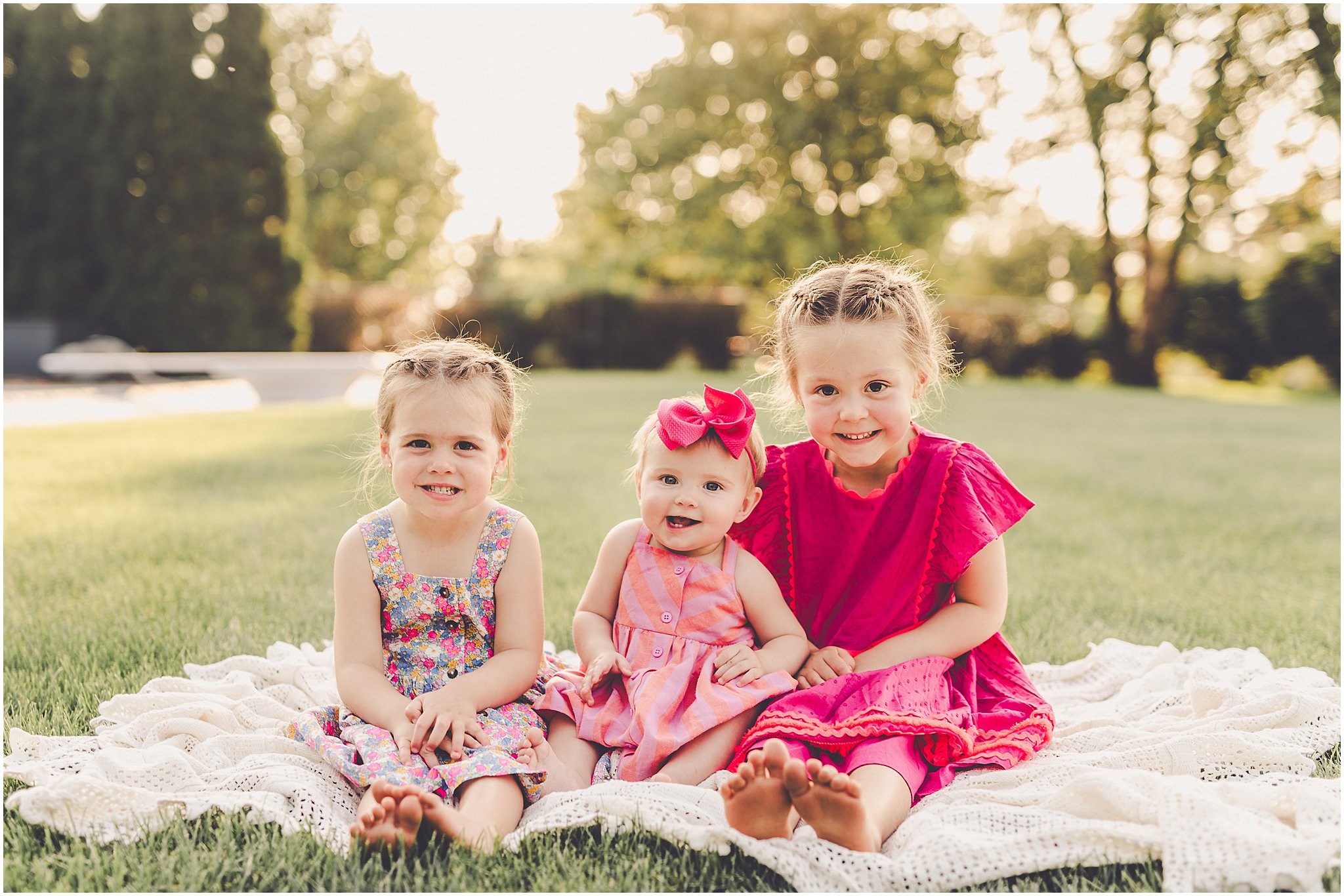 Celebrating baby Kambry's eight-month milestone with a playful, pink-filled summer backyard session in Kankakee County.