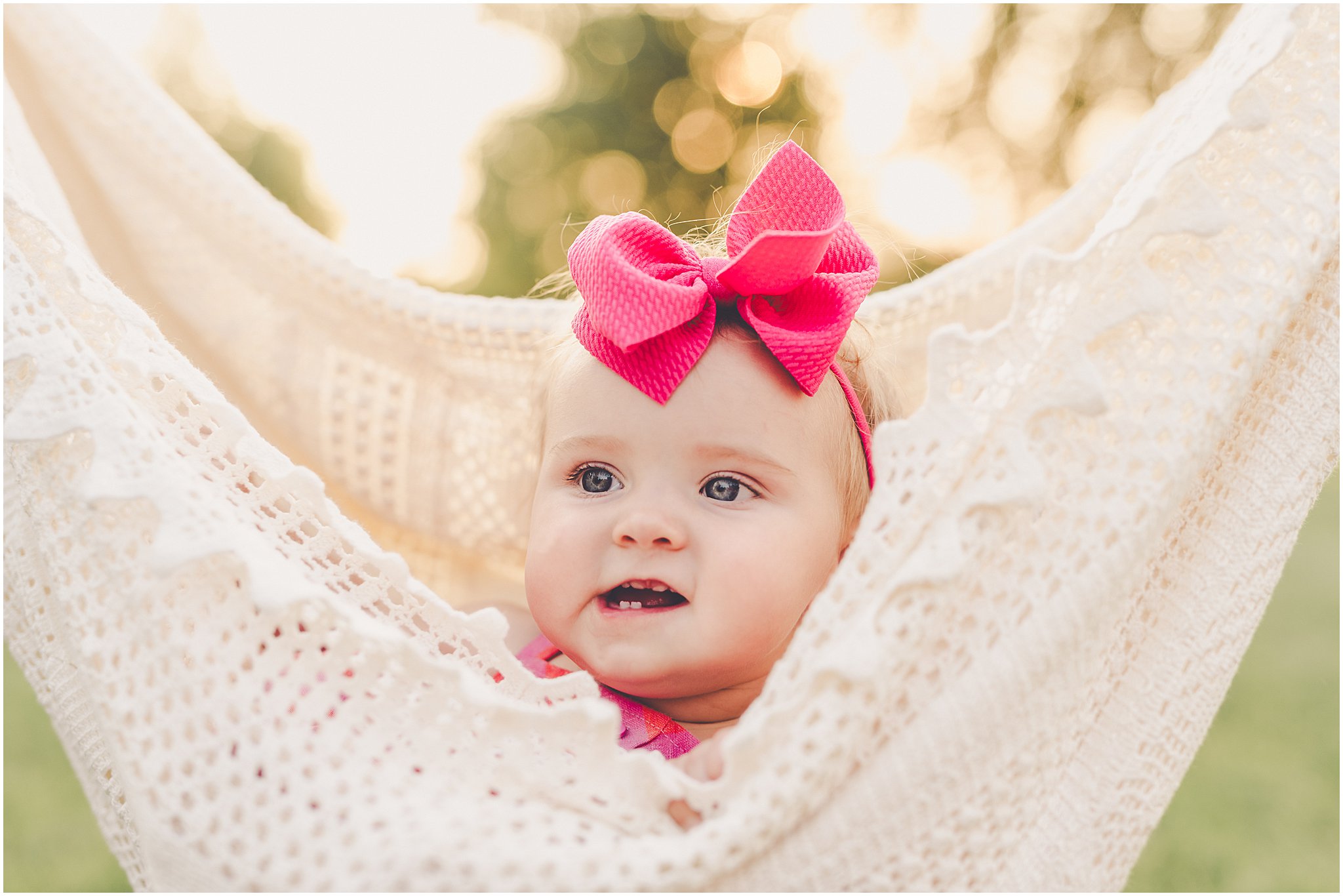 Celebrating baby Kambry's eight-month milestone with a playful, pink-filled summer backyard session in Kankakee County.