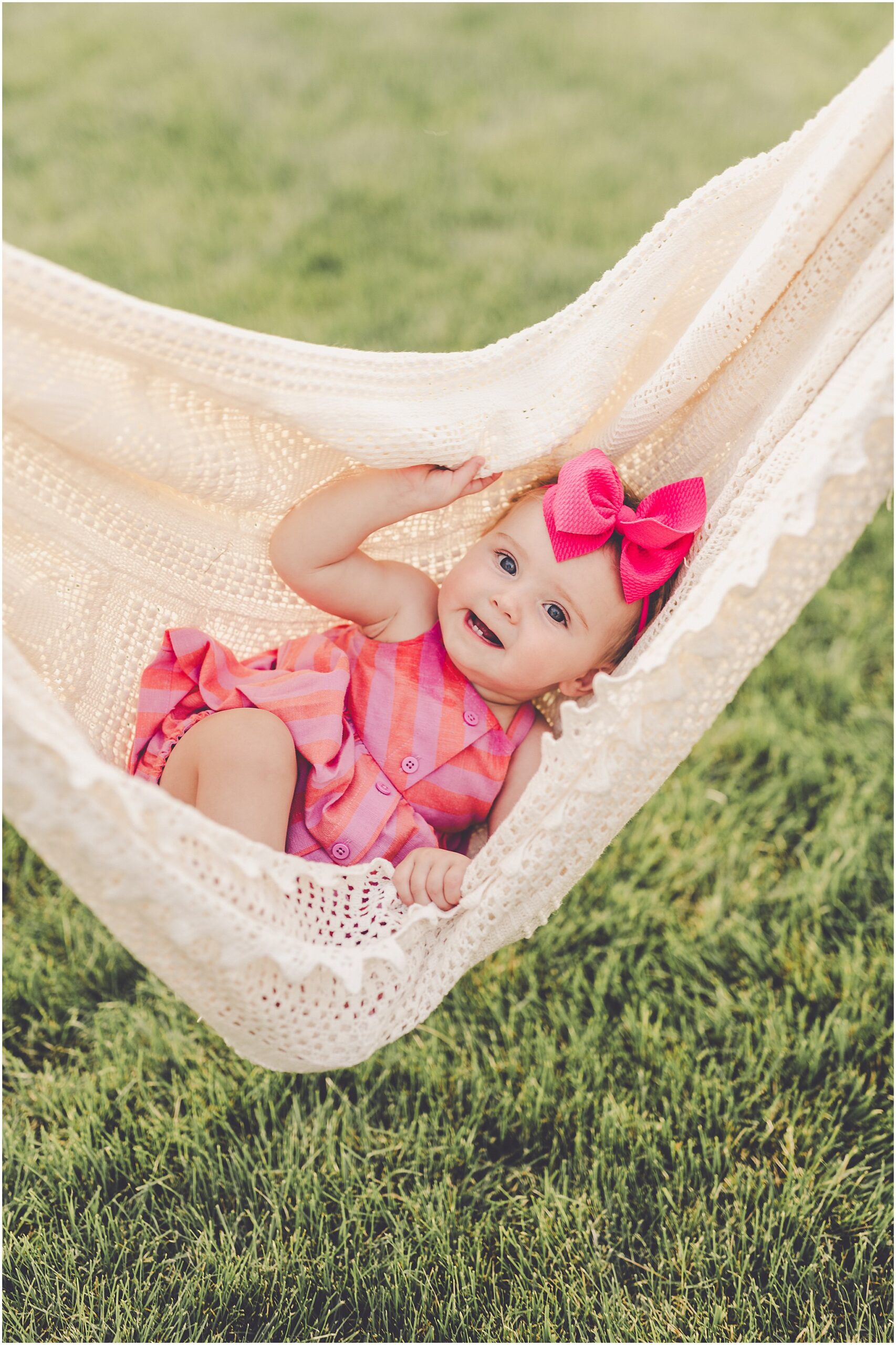 Celebrating baby Kambry's eight-month milestone with a playful, pink-filled summer backyard session in Kankakee County.