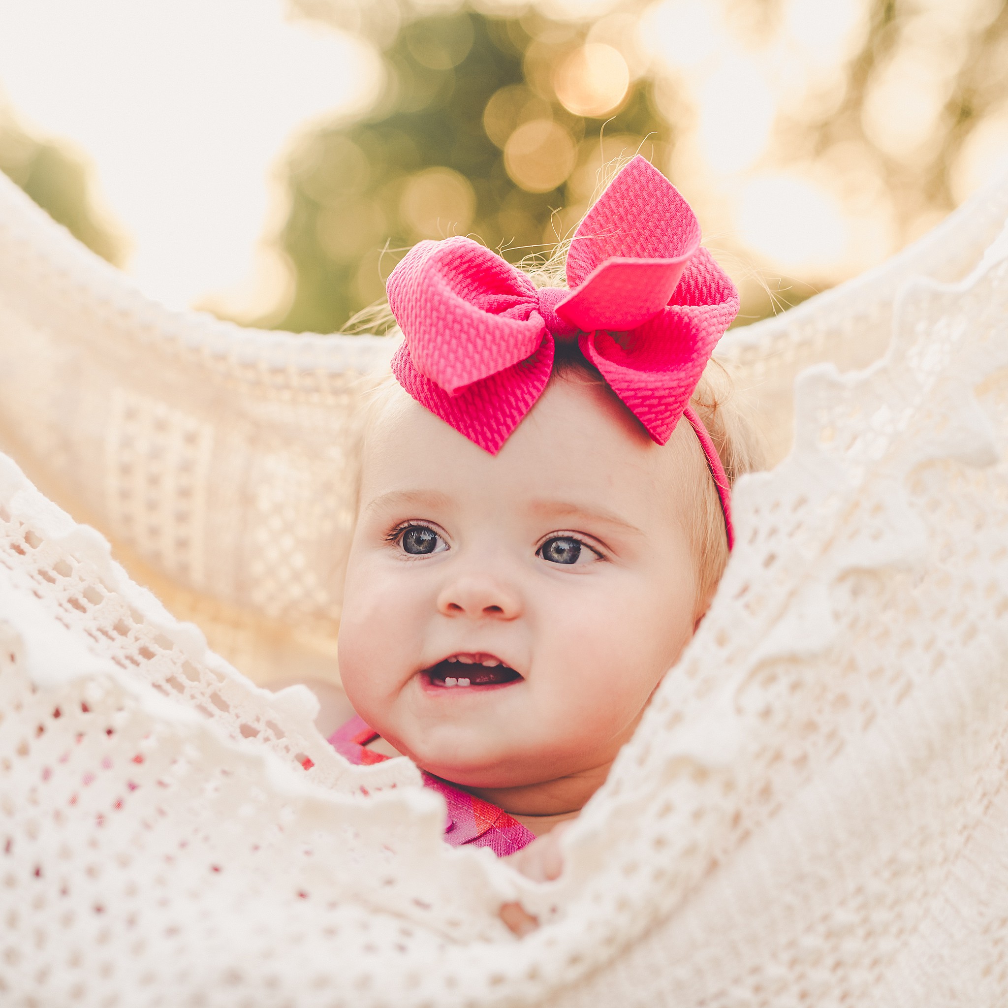 Celebrating baby Kambry's eight-month milestone with a playful, pink-filled summer backyard session in Kankakee County.