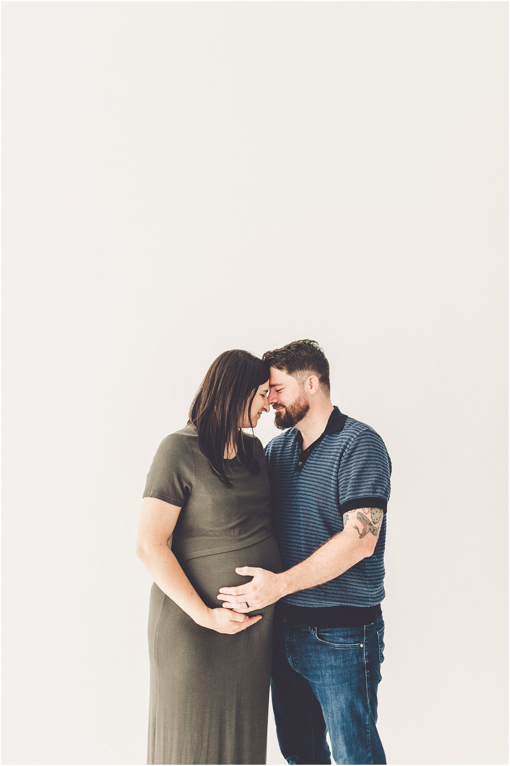 Michelle and Derek celebrate their growing family with a simple and sweet studio maternity session at Studio 388 in downtown Kankakee, Illinois.