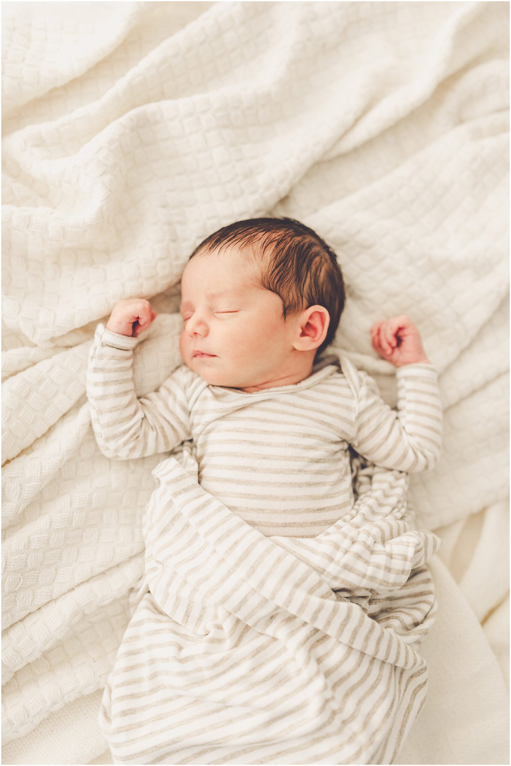 A sleeply, snuggly newborn baby in the Kankakee studio with Kankakee family & newborn photographer Kara Evans Photographer.